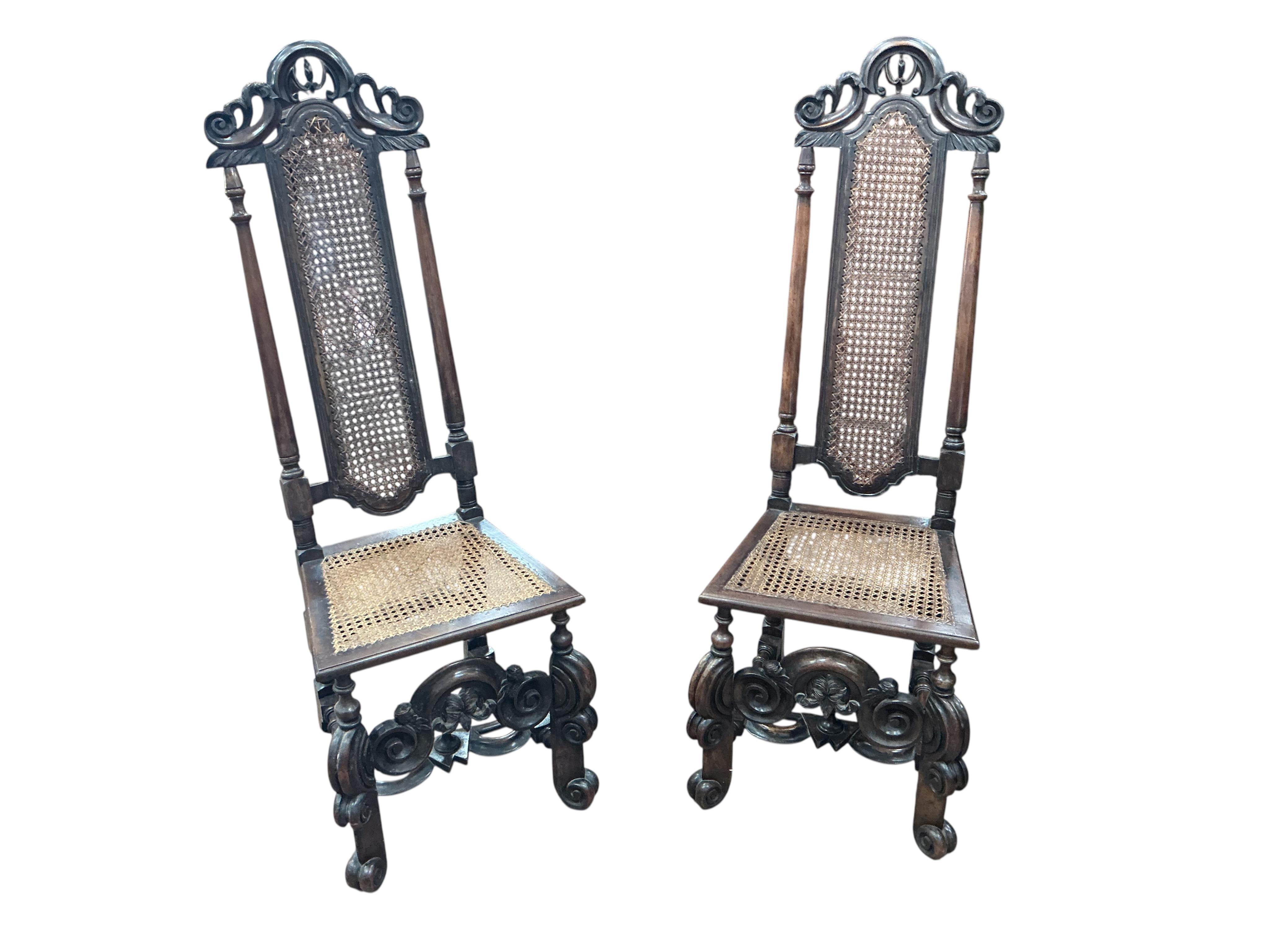 A pair of William and Mary walnut and cane work side chairs, width 46cm, depth 48cm, height 116cm